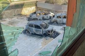 من تلك النافذة المحطمة، نرى السيارات التي أشعل فيها المستوطنون النيران