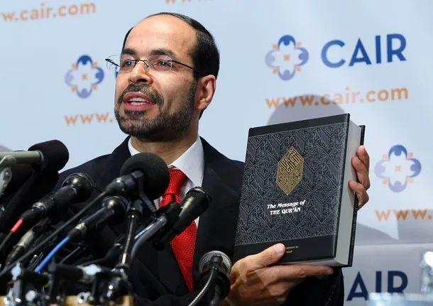 National-Executive-Director-of-Council-on-American_Islamic-RelationsCAIR-Nihad-Awad-holds-a-translated-copy-of-the-Quran-as-he-speaks-news-conference-at-the-headquarters-of-CAIR