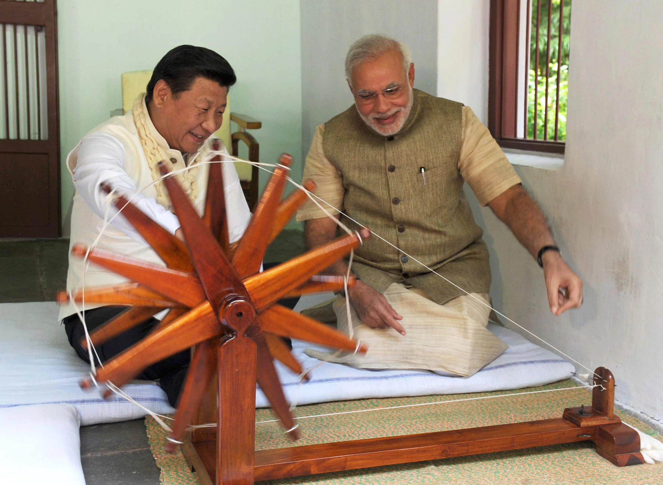 e098d080-43cf-11e4-8784-23e8aa1aebd2_Xi-with-Modi-charkha-PIB