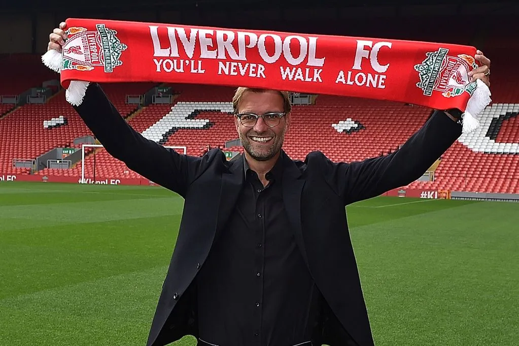 jurgen-klopp-new-manager-of-liverpool-at-anfield-holds-up-a-scarf