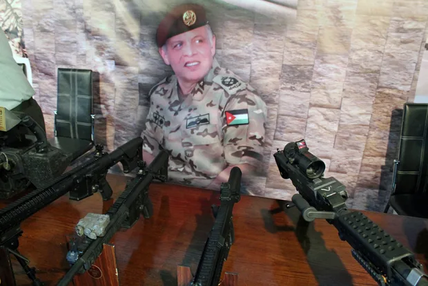 weapons_at_sofex_in_front_of_a_picture_of_king_abdullah_meesara_elizbeth_williams_0