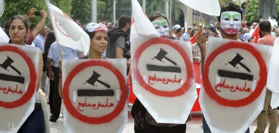 demonstrators-hold-placards-reading