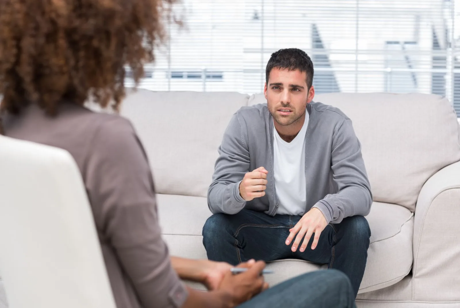 man-gestures-as-he-speaks-to-therapist