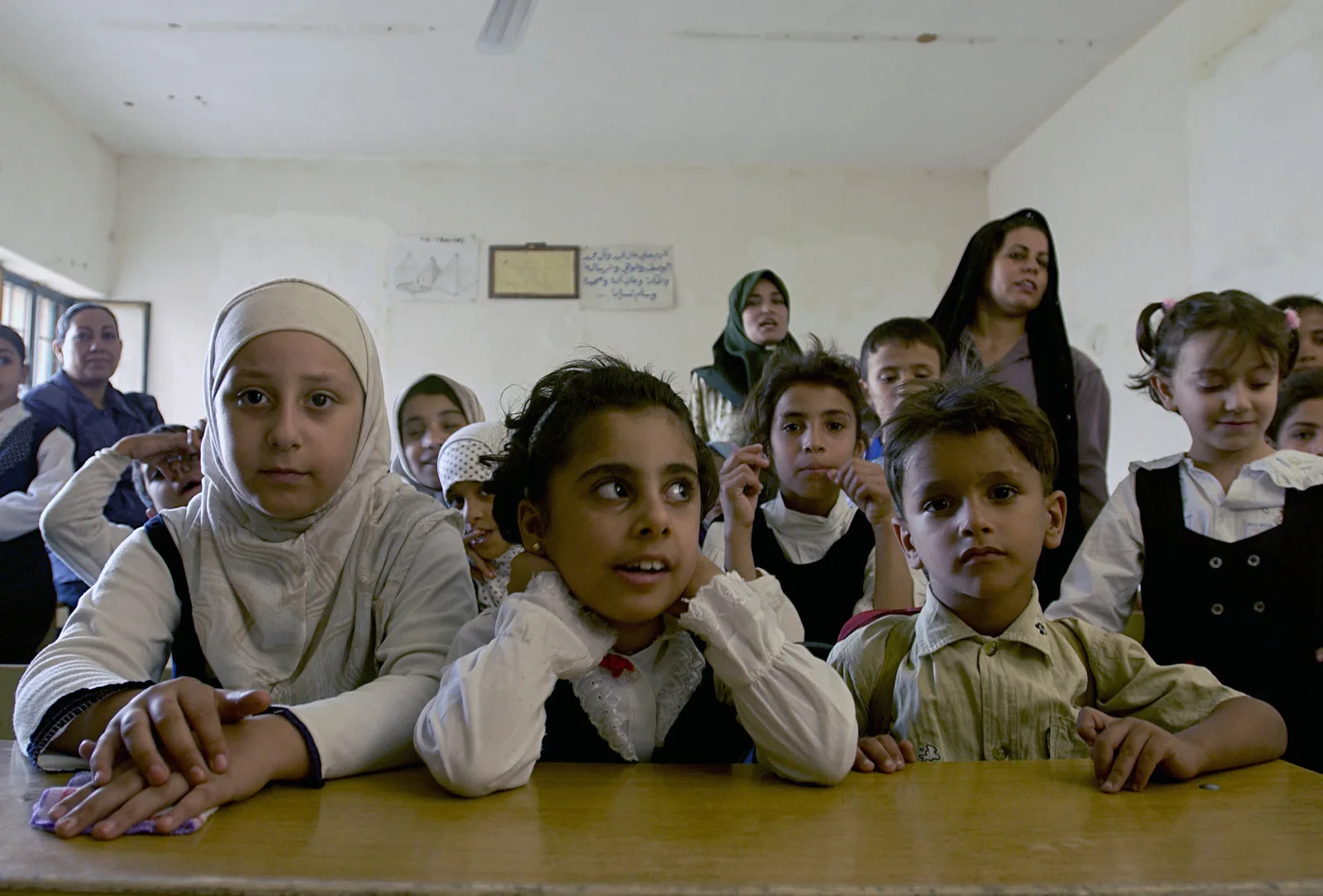 iraqi-students-of-a-newly-opened-grade-school-listen-as-teachers-give-out-their-7799c2-1600