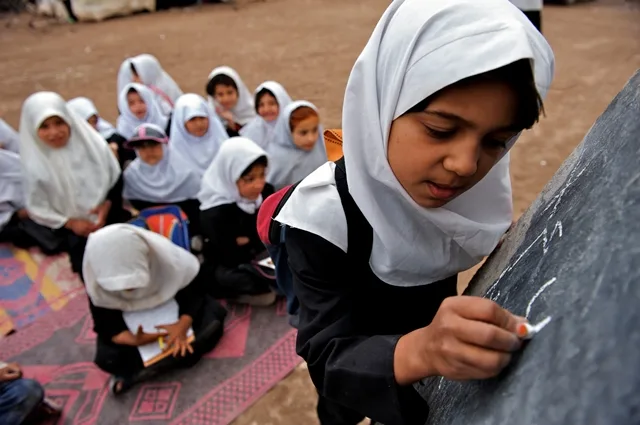 literacy-girls_writing_on_black_board