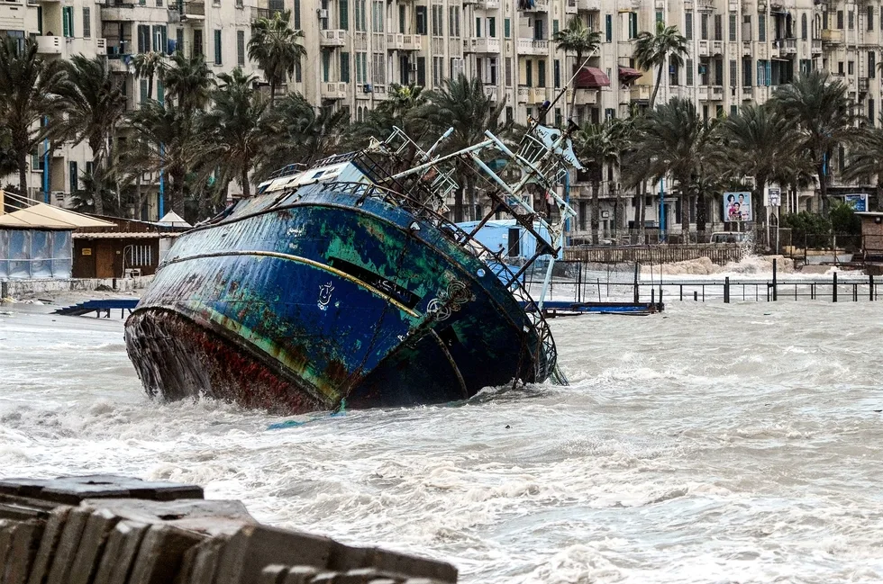 january_19_2018_shows_waves_breaking_against_the_hull_of_a_ship_on_the_shore_of_the_egyptian_port_city_of_alexandria_during_the_winter_storm_afp