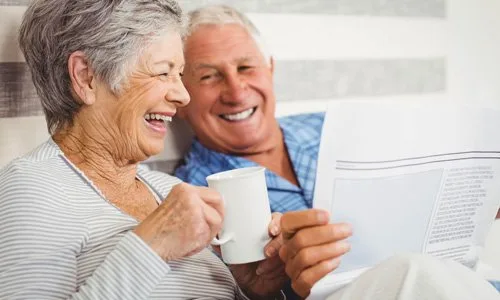 older-couple-reading-in-bed-smiling-500