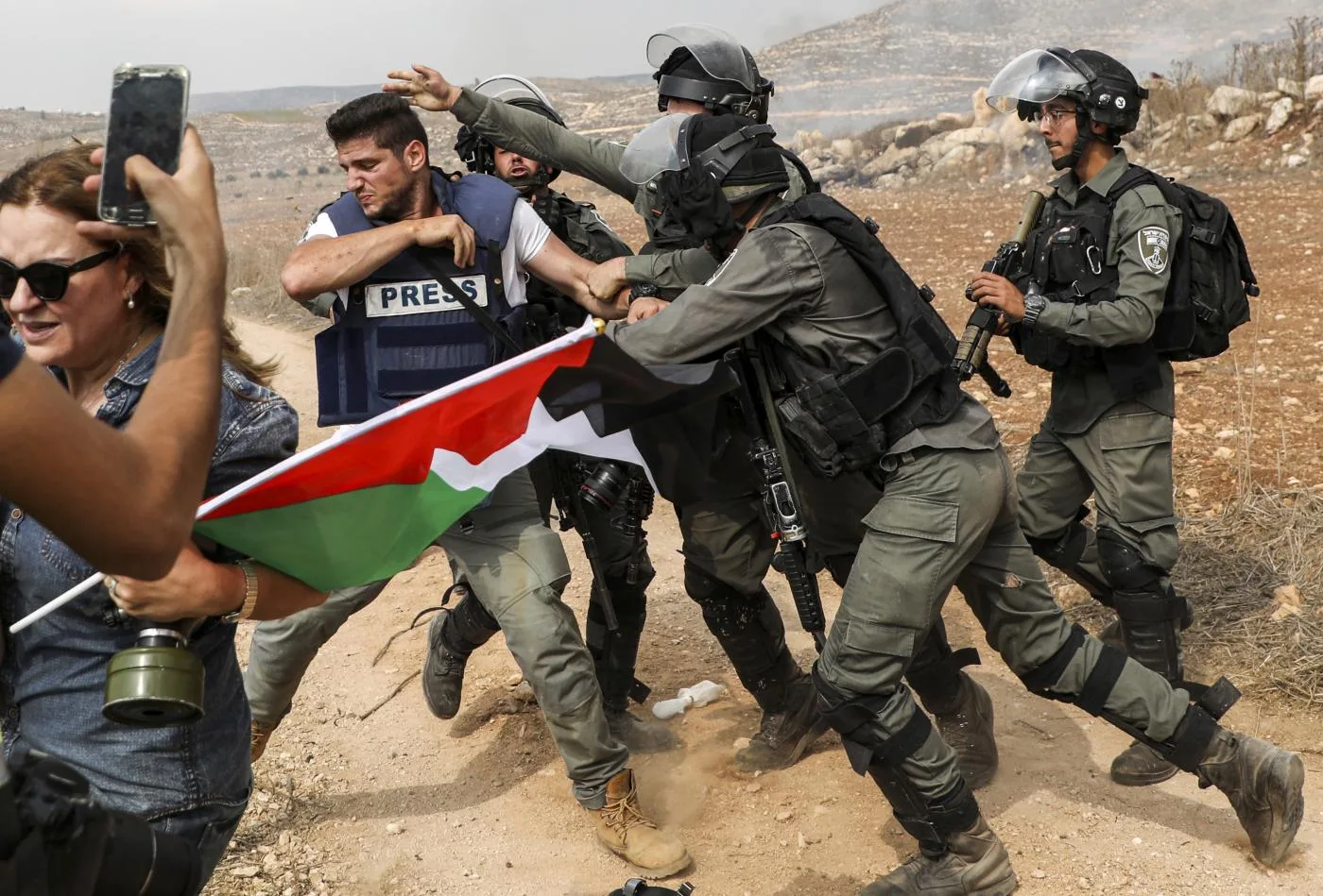 حرس الحدود الإسرائيلي يتشاجر مع مصور صحفي في أثناء تغطيته لاشتباكات بين القوات الإسرائيلية والمتظاهرين الفلسطينيين
