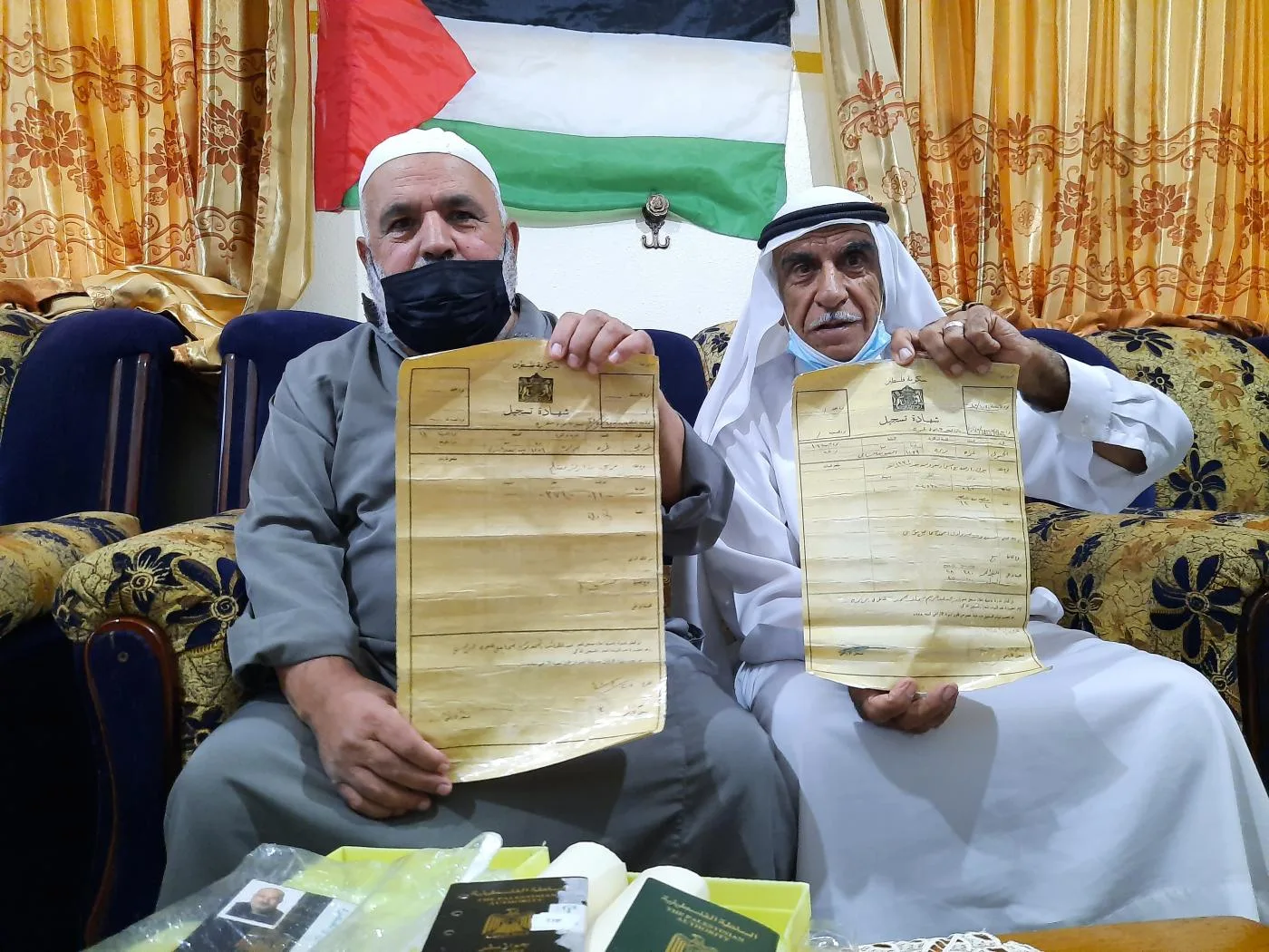 Abu Hamed ( on the left) and his 70-year-old Mohammed hold their land titles