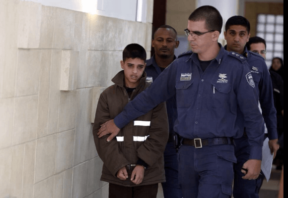 Ahmad-Manasra-being-led-by-Israeli-authorities-in-a-detentian-facility-Source-Twitter-580x400