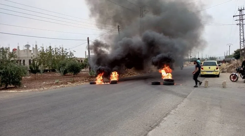 Tires burn as demonstrators protest against the Syrian government decision on increasing the prices of fuels in Sweida, Syria, August 17,2023. Sweida 24/Handout via REUTERS THIS IMAGE HAS BEEN SUPPLIED BY A THIRD PARTY. NO RESALES. NO ARCHIVES. MANDATORY CREDIT