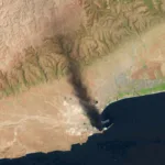 صورة ملتقطة بواسطة قمر صناعي تظهر حريقاً اندلع بعد أيام من هجوم إيراني استهدف ميناء صلالة في سلطنة عمان